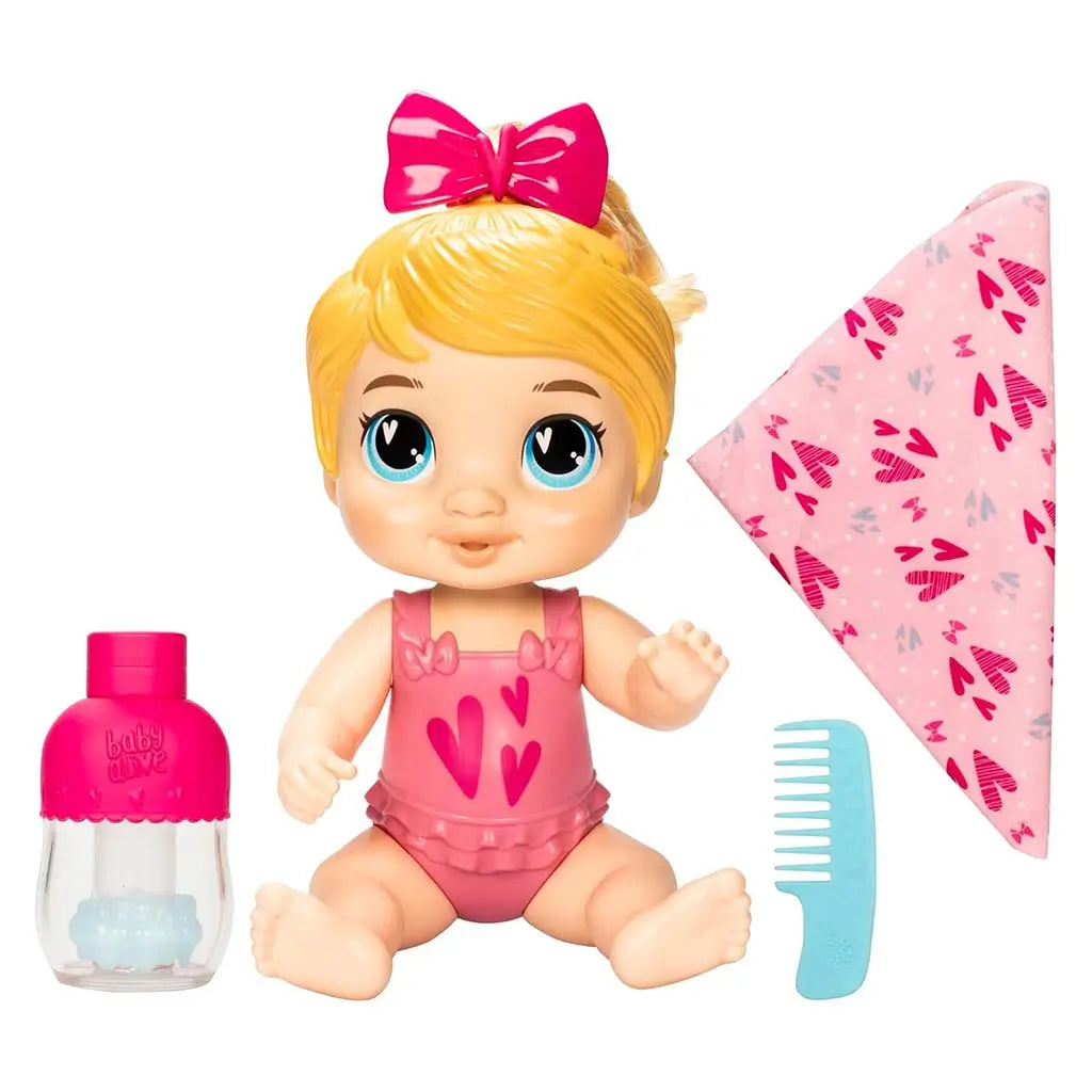 Baby Alive Harper Hugs doll set showing blond baby doll with big blue eyes, pink heart swimsuit, bottle, comb and blanket arranged neatly on a white backdrop for playful styling fun.