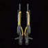 Bandai RG Wing Gundam Zero model kit accessories image presents two identical dark gray and gold twin buster rifles side by side, highlighting molded panel lines and matching handles on a black backdrop.