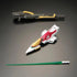 Bandai RG Wing Gundam Zero model kit accessories display includes a dark gray and gold buster rifle, a red and white transformable flyer unit and a long green beam saber part arranged on a neutral surface.