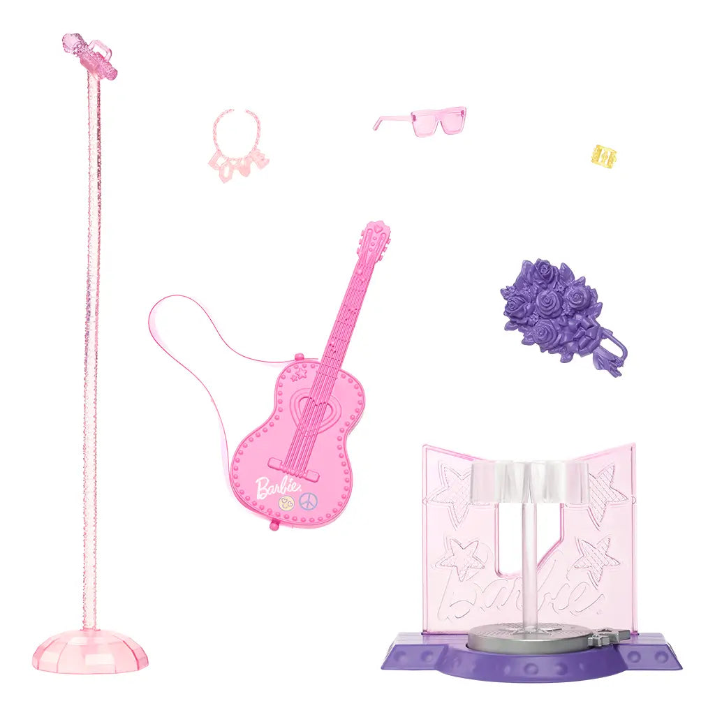 Barbie 65th Anniversary Pop Star Doll accessories include a pink guitar, microphone stand, stage base, purple bouquet, pink sunglasses, gold bracelet, and necklace for performance play.