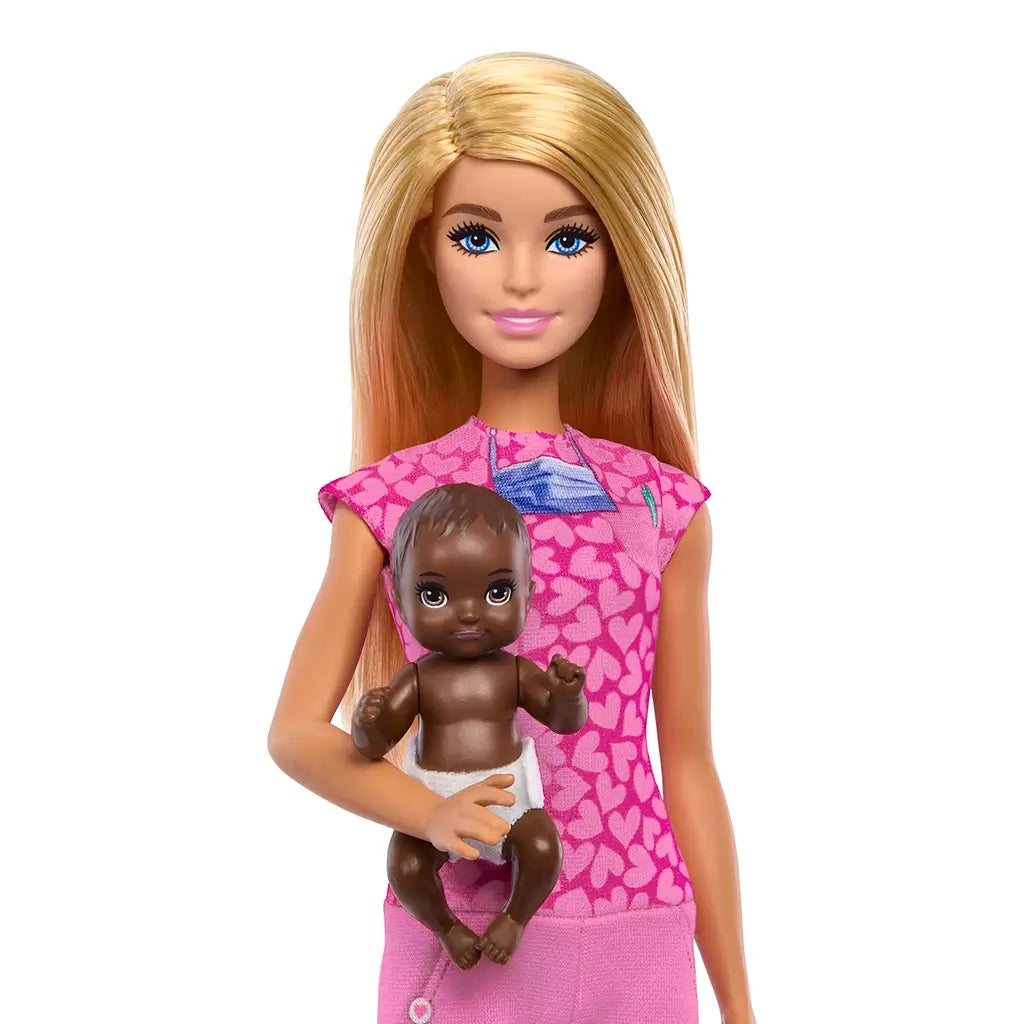 Close-up of Barbie baby doctor doll in pink scrubs holding infant doll in diaper, highlighting nurturing play theme with detailed design and bright colors for imaginative storytelling.