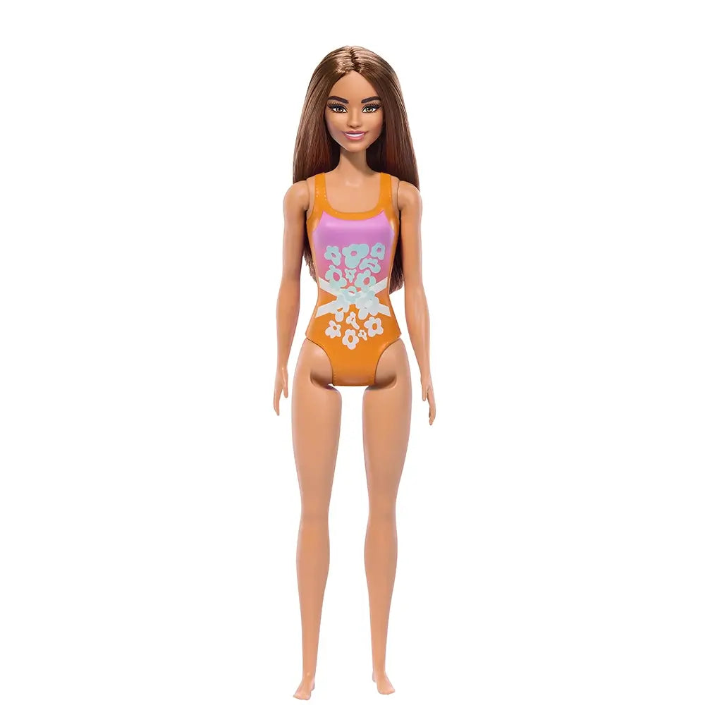 Barbie doll wearing an orange and pink floral swimsuit with cut-out sides. The doll has long brown hair and is standing upright. Ideal for imaginative play and collectors. Toy store product.