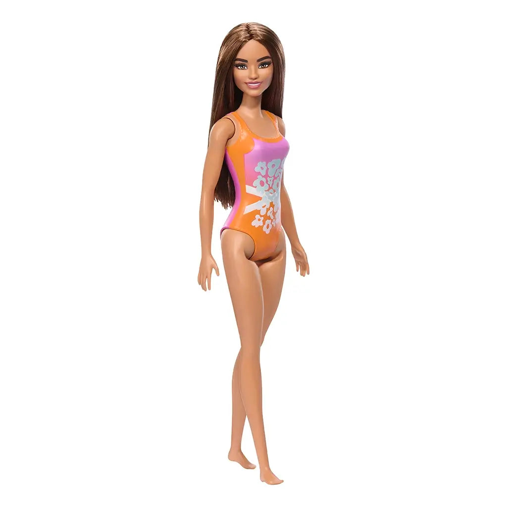 Barbie fashion doll with long brown hair in a floral swimsuit, standing upright with bare feet; ideal for kids' pretend play and doll collection.