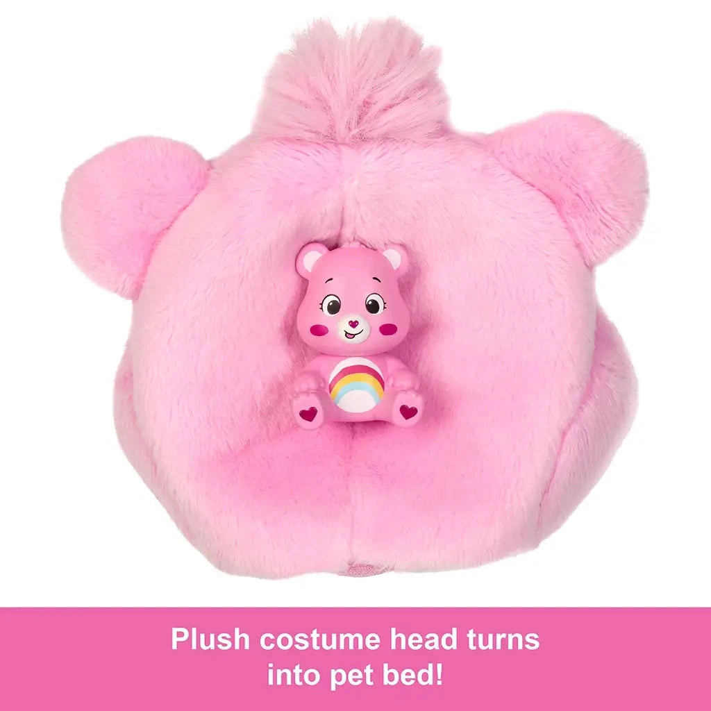 Plush pink bear costume head with ears transforms into a pet bed, includes a small collectible Care Bear toy with rainbow belly sitting at the center.