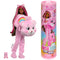Barbie Cutie Reveal doll with long hair wearing a pink Cheer Bear costume, holding plush bear head with rainbow belly design, next to included Care Bear figure and packaging.