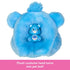 Blue Grumpy Bear plush head from Barbie Cutie Reveal doubles as a pet bed, shown with small collectible Care Bears figure sitting inside for imaginative doll and pet playtime.