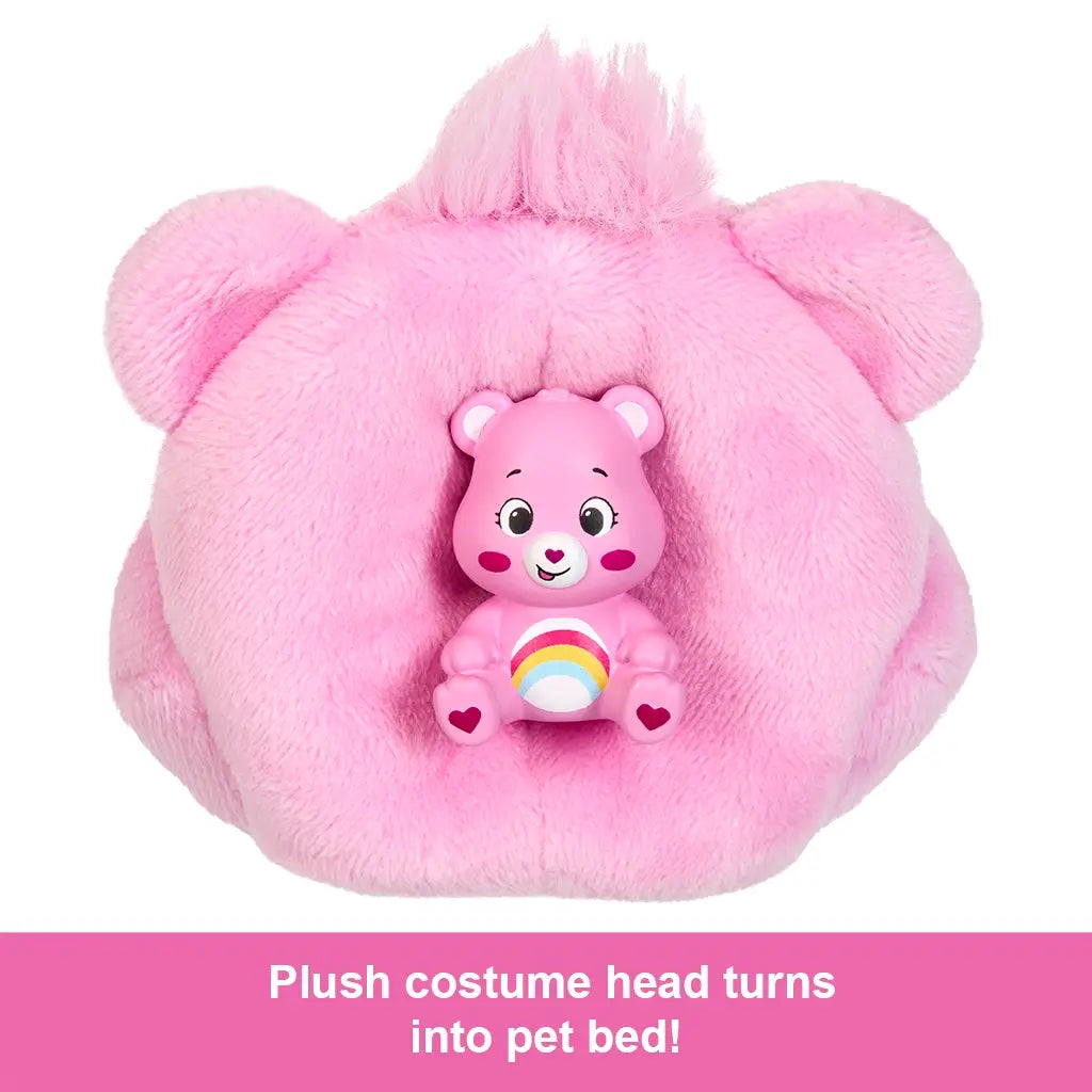 Plush pink Care Bear costume head turned into a pet bed holding a small rainbow-bellied Care Bear mini figure, part of Barbie Cutie Reveal Care Bears set.