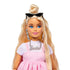 Close-up of Barbie Deluxe Style doll with blonde hair in a top knot, wearing pink dress, silver “Barbie” necklace, statement earrings, and black sunglasses.