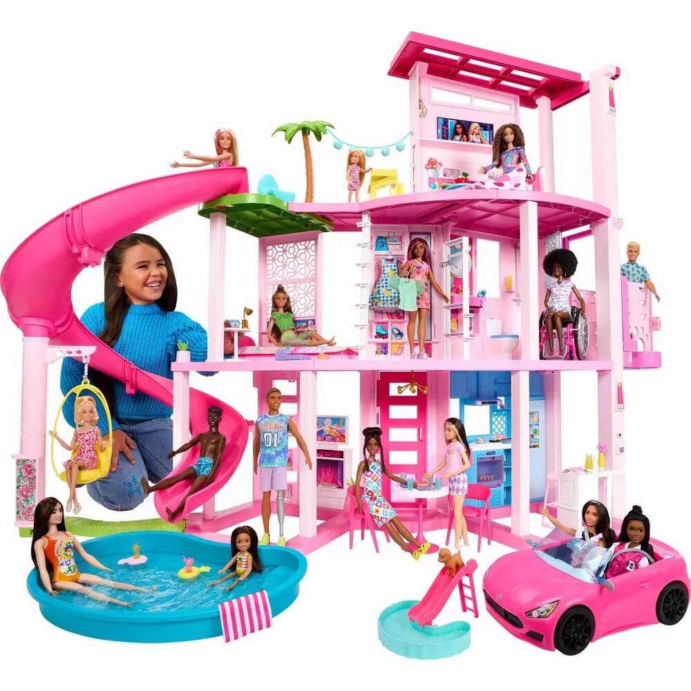 Girl playing with her dolls on the Barbie Dreamhouse with Pool and Slide Playset.  Dolls not included with purchase