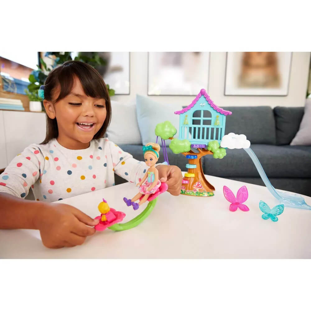Girl playing with the Barbie Dreamtopia Doll and Treehouse Playset