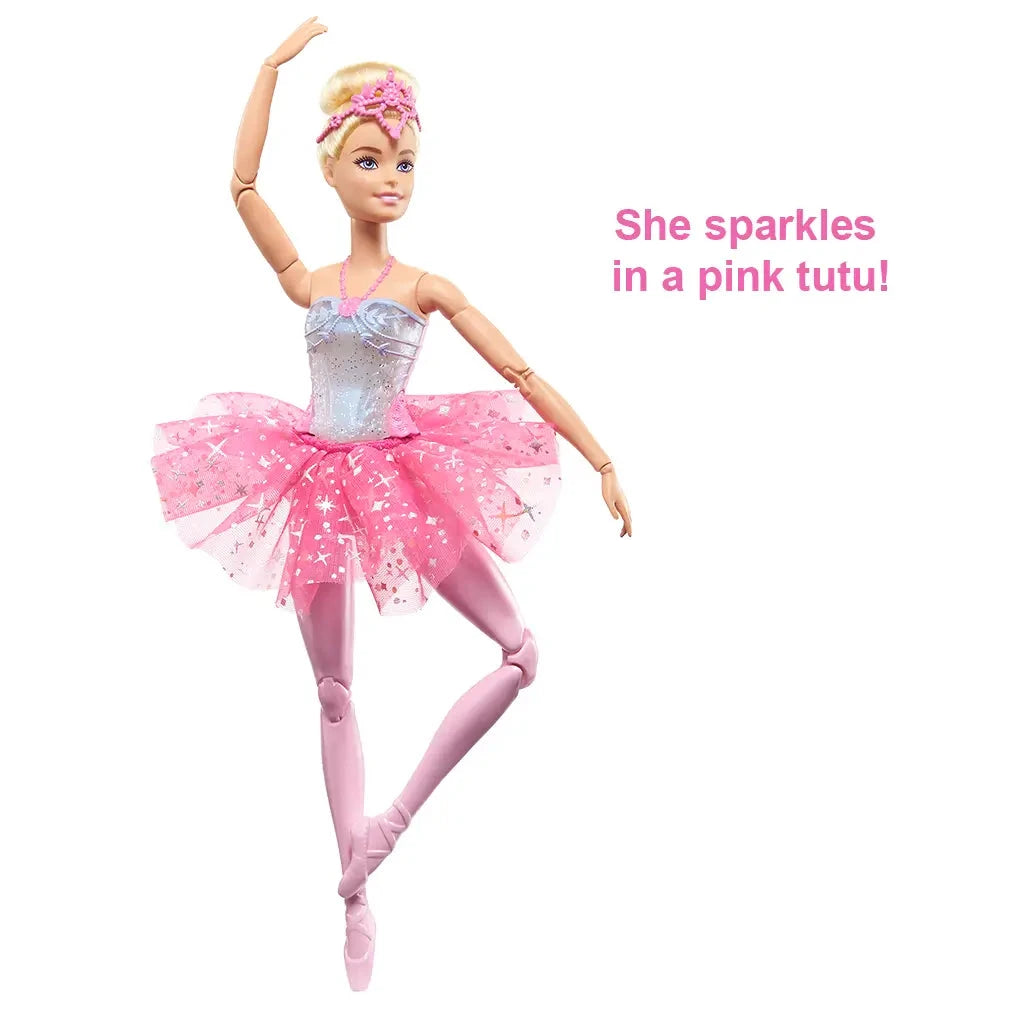Barbie Dreamtopia Twinkle Lights Ballerina doll stands in a pink star-pattern tutu and silver glitter bodice, holding a ballet pose with one leg raised elegantly forward.