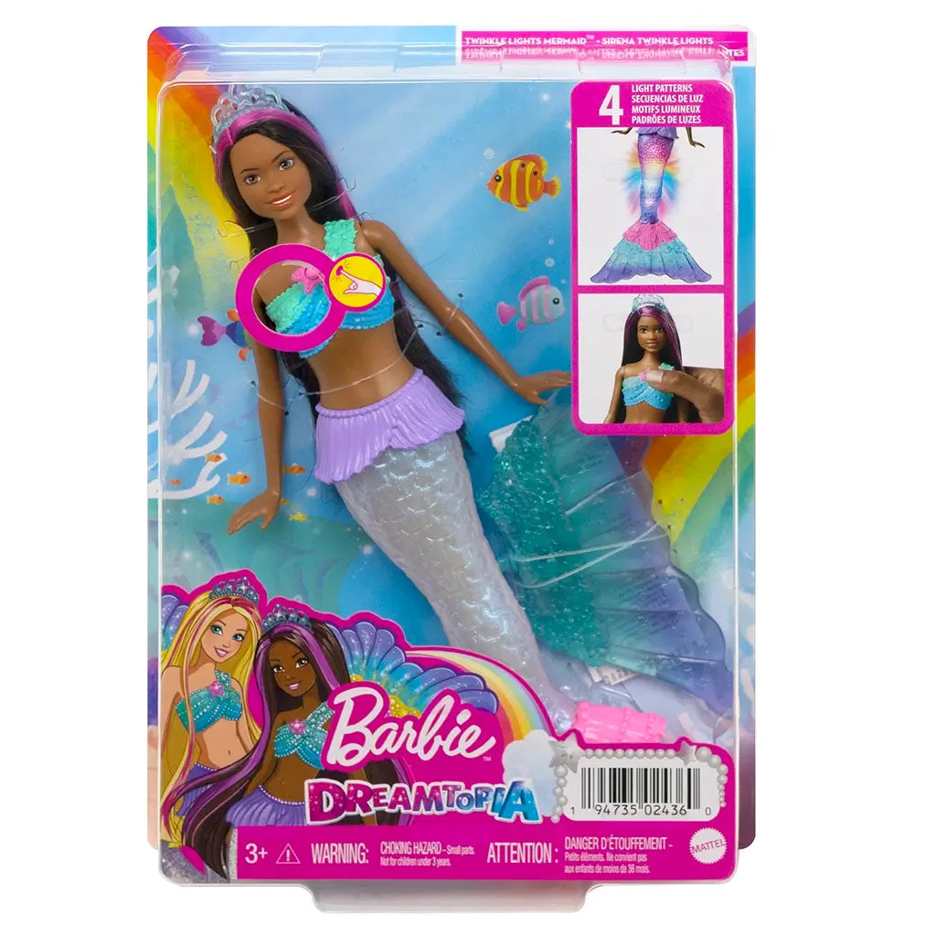 Barbie Dreamtopia Twinkle Lights Mermaid doll displayed in retail packaging with ocean background, colorful fish, product details, and illustrated mermaids on the front.