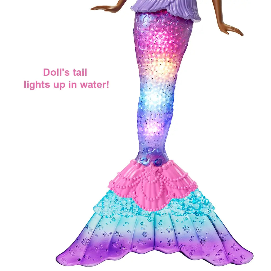 Barbie Dreamtopia Mermaid doll’s colorful textured tail glows in rainbow lights, transitioning from pink to blue to purple, designed to illuminate when placed in water.