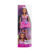 Barbie Fashionistas doll in pink top, purple ruffled skirt, and sunglasses is displayed in a clear package with branding, holding a white cane for representation of blind individuals.