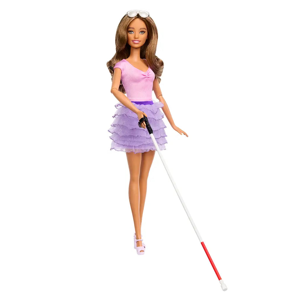 Barbie Fashionistas doll with long brown hair wears a pink top and layered purple ruffled skirt, accessorized with pink platform sandals, white cane, and white sunglasses on her head.