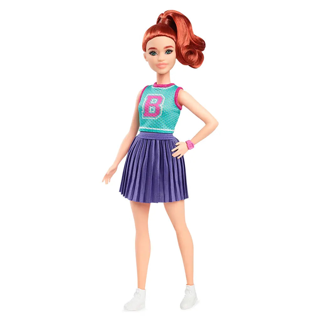 Full Barbie Fashionistas 232 doll with long red hair in high ponytail, teal sleeveless top with pink letter B, purple pleated skirt, and white sneakers.