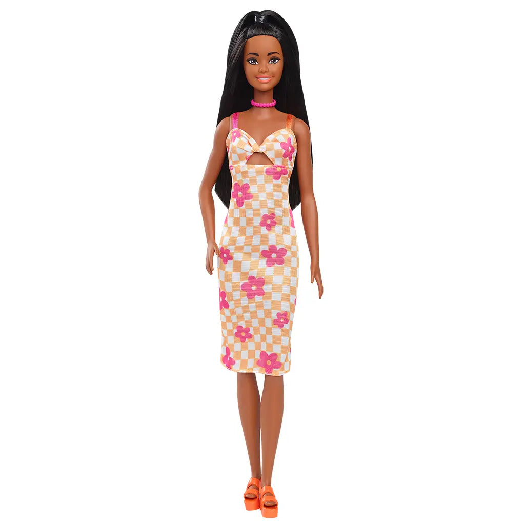 Barbie Fashionistas 233 doll standing, wearing a yellow and white checkered midi dress with pink flowers, orange platform sandals, and a pink bead necklace.