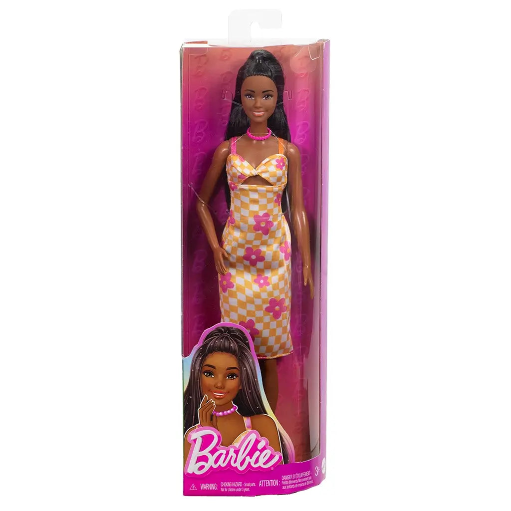 Barbie Fashionistas 233 doll in packaging, wearing a yellow and white checkered midi dress with pink flowers, orange platform sandals, and a pink bead necklace.