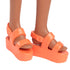 Close-up of Barbie Fashionistas 233 doll’s bright orange platform sandals with two straps over the foot.