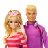 Barbie and Ken dolls with a pink and red striped dress and purple sweater on a white background