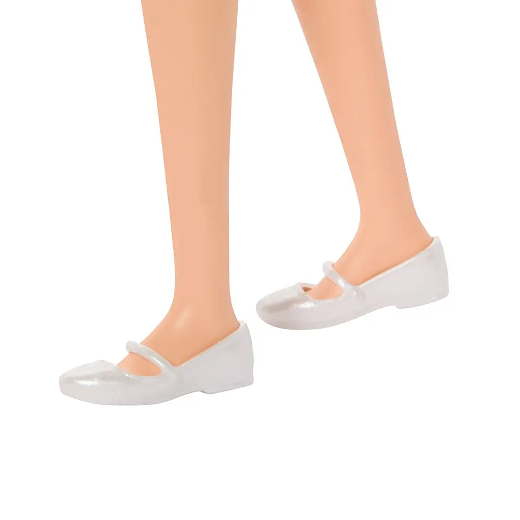 Close-up view of Barbie Fashionistas doll 224’s shiny white flats with strap detail, highlighting the simple design that complements the doll’s pink gingham dress.