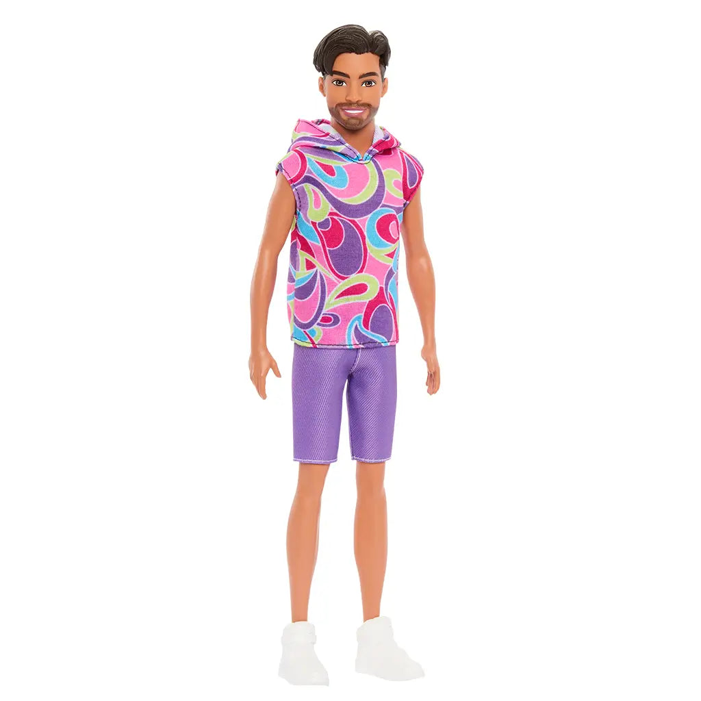 Barbie Fashionistas Ken doll #227 shown at an angle, wearing multicolor swirl-patterned sleeveless hoodie, purple shorts, and white sneakers.