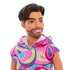 Close-up of Barbie Fashionistas Ken doll #227 with brunette hair, trimmed beard, and bright smile, wearing a sleeveless multicolor swirl hoodie.