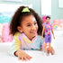 Young girl smiling while holding Barbie Fashionistas Ken doll #227 dressed in a colorful sleeveless swirl hoodie, purple shorts, and white sneakers.