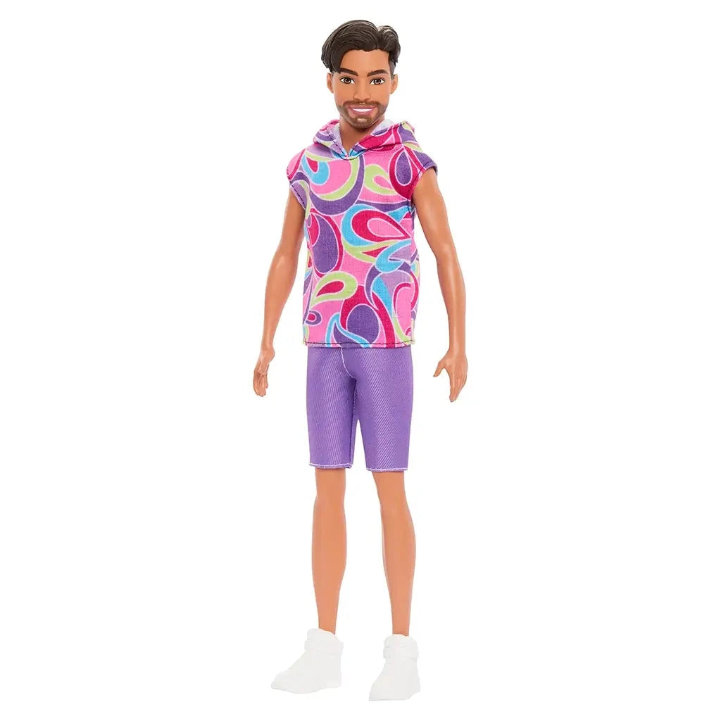 Full-length view of Barbie Fashionistas Ken doll #227 wearing a colorful sleeveless swirl hoodie, purple shorts, and white sneakers.