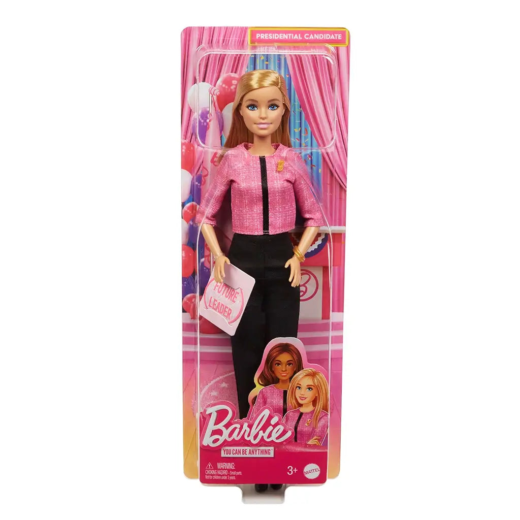 Barbie Future Leader doll packaged in box with pink political campaign background, wearing pink jacket and black pants, holding sign that reads Future Leader for kids’ empowerment.
