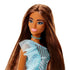 Barbie fashion doll with long straight brown hair wears a shimmering blue polka dot one-shoulder dress with mesh ruffle, matching choker, and pink lipstick against white backdrop.