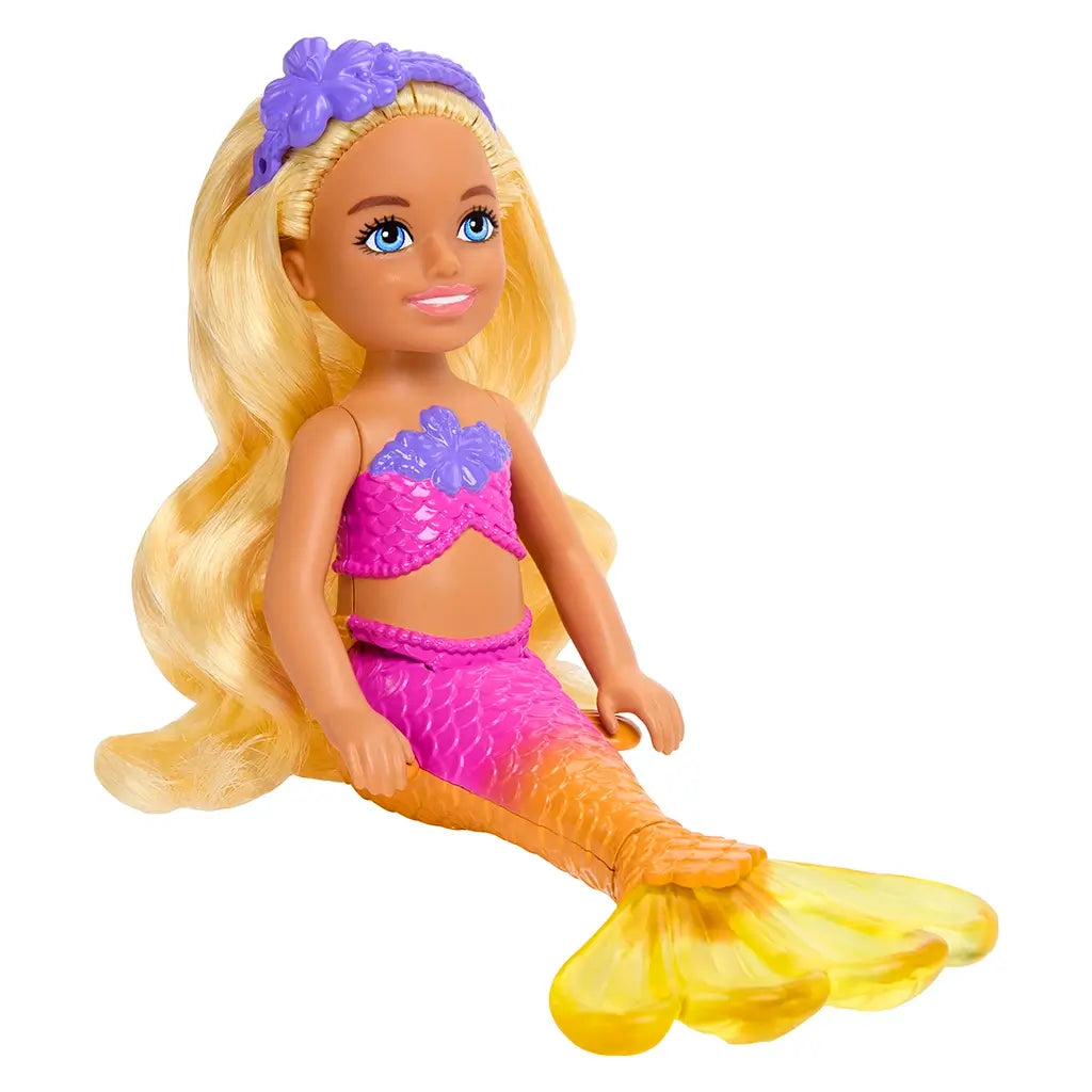 Barbie Mermaid Chelsea doll with long blonde hair, wearing a pink and purple mermaid outfit, seated with a bright orange-to-yellow tail and smiling face.