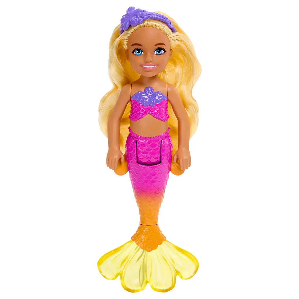 Full view of Barbie Mermaid Chelsea doll standing upright with long blonde hair, pink and purple mermaid top, orange scales, and translucent yellow tail fin.