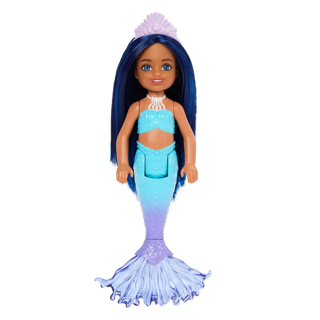 Barbie Chelsea mermaid doll standing upright with long straight blue hair, lavender shell crown, aqua seashell top, and detailed blue-to-purple mermaid tail with wide fin.