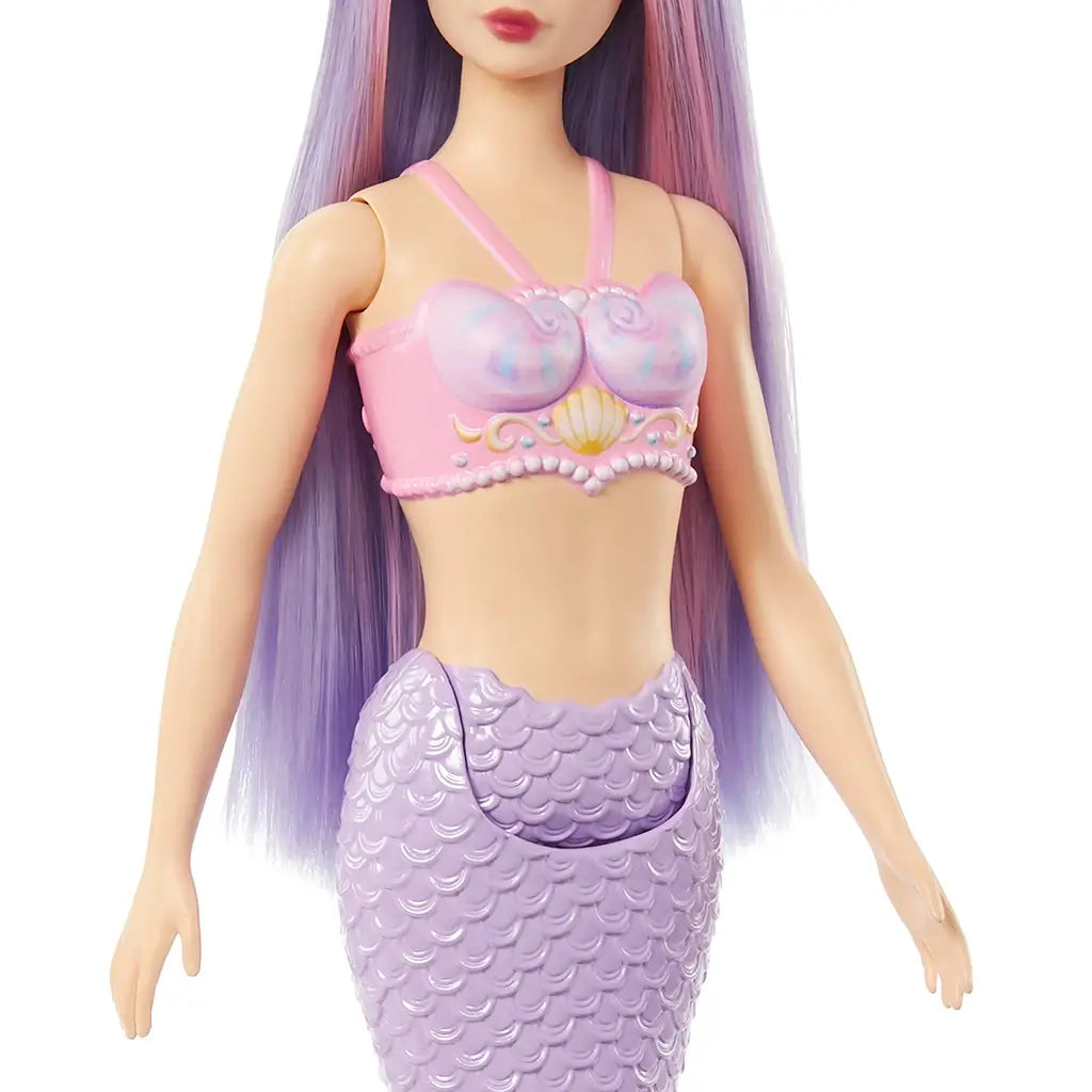 Closeup of Barbie mermaid doll’s torso, showing pink seashell bra with gold seashell detail, pearl-like trim, and lavender scale-patterned mermaid tail. Designed for imaginative play, this Barbie mermaid doll blends colorful fantasy details with a shimmering aquatic theme, perfect for collectors or kids.