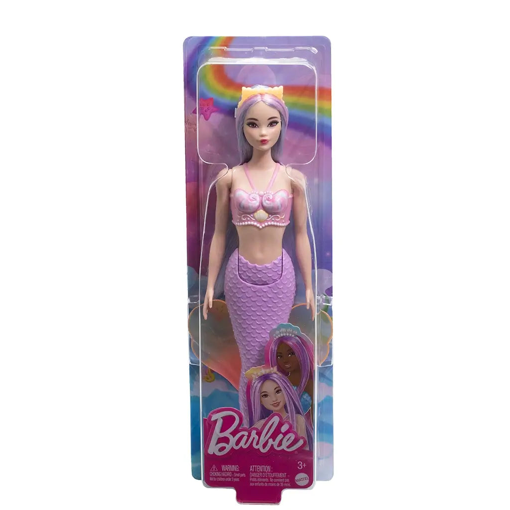 Barbie mermaid doll in retail packaging, featuring rainbow background, Barbie logo, and doll dressed in seashell top with lavender mermaid tail and pink fin. Designed for imaginative play, this Barbie mermaid doll blends colorful fantasy details with a shimmering aquatic theme, perfect for collectors or kids.