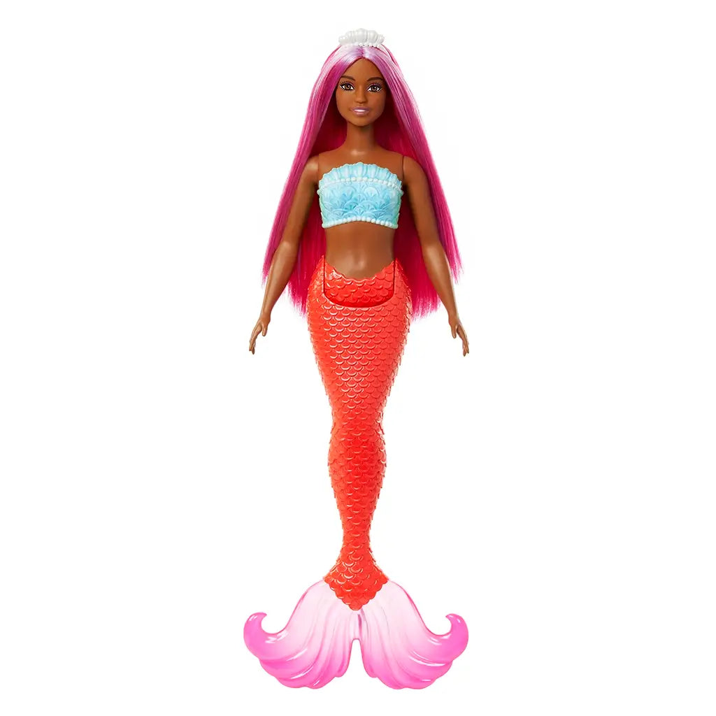 Front view of Barbie mermaid doll wearing turquoise seashell-style top and red scale mermaid tail with pink fins, long magenta hair, and white pearl-like tiara crown.