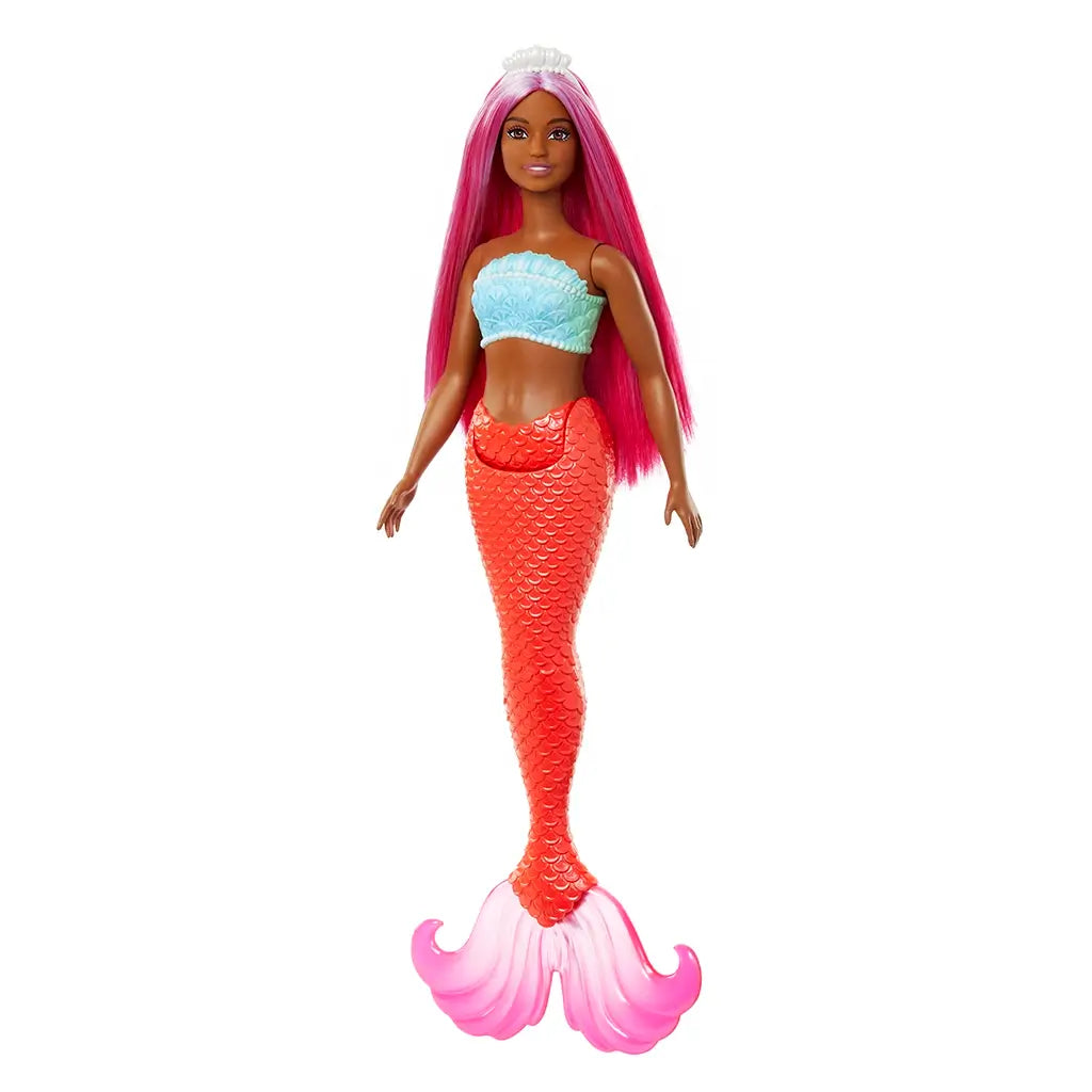 Barbie mermaid doll with long magenta hair, turquoise seashell-style top, and shimmery red scale tail ending in translucent pink fins, shown against a white background.