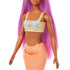 Close-up of Barbie mermaid doll’s torso showing peach starfish top with blue accents, orange scaled mermaid tail, and long flowing pink hair.
