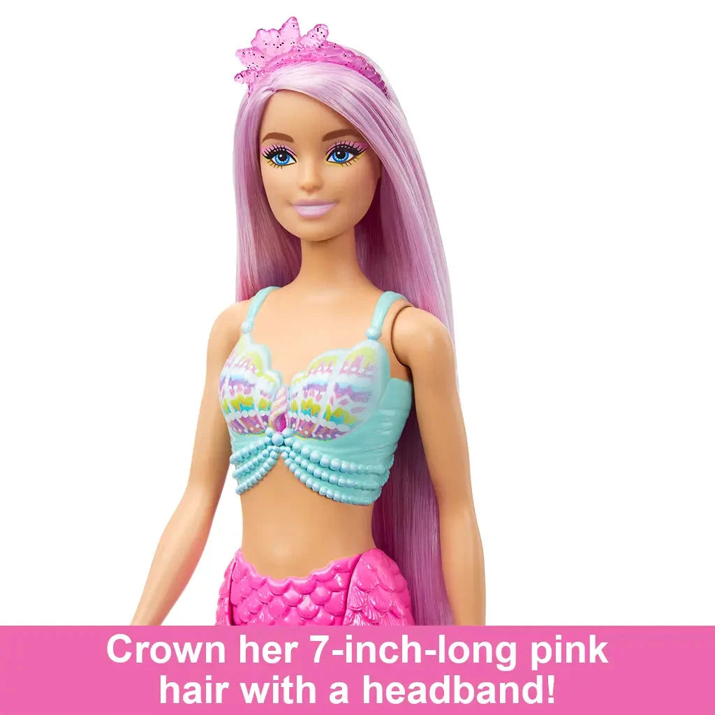 Barbie mermaid doll with long pink hair and a pink tiara headband, wearing a colorful shell-themed top and pink mermaid tail.