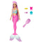 Barbie mermaid doll wearing a pink tail and pastel shell top, includes pink comb and colorful barrettes shaped like bows, animals, and sea icons.