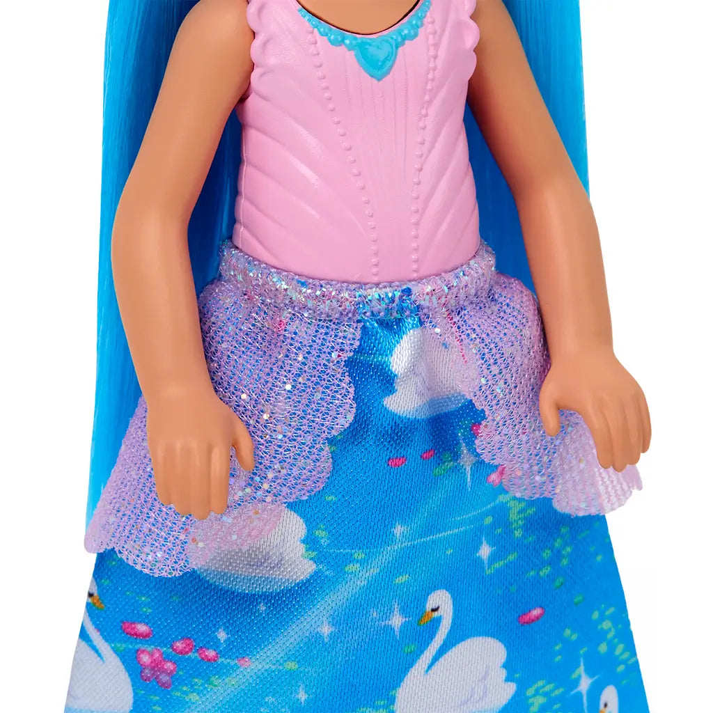 Close-up of Barbie Chelsea doll’s outfit featuring a sleeveless pink bodice, purple glittery mesh overlay, and a bright blue skirt decorated with swans and floral details.