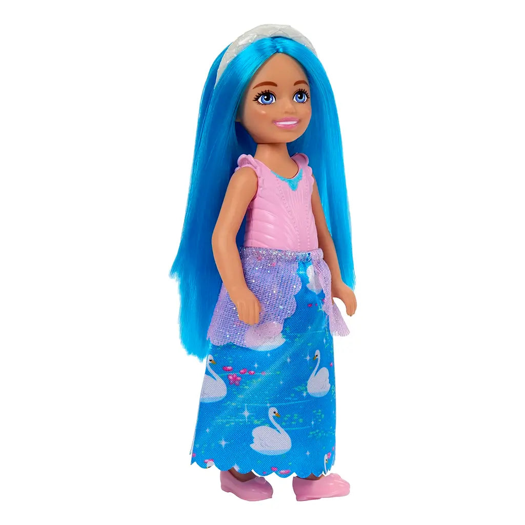 Barbie Chelsea doll dressed in a pink bodice with blue gem detail and long skirt patterned with white swans, layered with glittery mesh, paired with pink shoes.