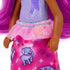 Barbie Chelsea doll outfit closeup showing purple textured top with pink glittery tutu and bright pink skirt decorated with playful dog illustrations and heart patterns.