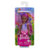 Front of Barbie Chelsea doll package with doll in clear plastic, rainbow background, floral details, and Barbie logo in pink over sparkly backdrop.