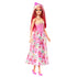 Full-length Barbie doll wears a pink floral bodice with embossed details, pearl necklace, and long satin skirt printed with multicolored butterflies, paired with pink high heels.