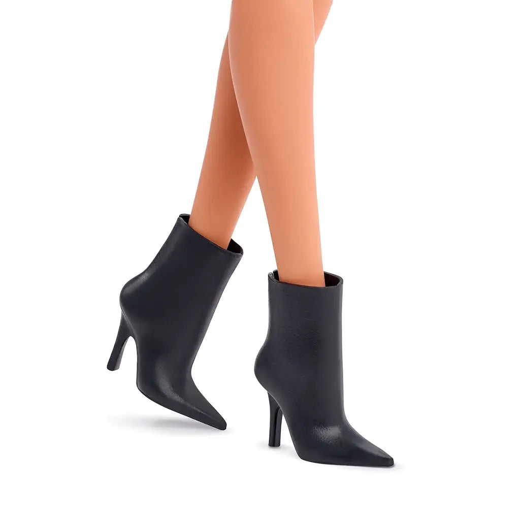 Close-up of Barbie Signature Basics 2025 Series 1 Model 01 doll’s black pointed-toe ankle boots with high heels, emphasizing the textured material and slim silhouette design.