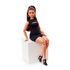 Poseable Barbie Signature Basics Model 05 doll seated on white block, wearing black dress and heels, showcasing her flexible articulated limbs.