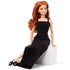 Poseable Barbie Signature Basics 2025 Model 4 fashion doll with flowing red hair and black sleeveless maxi dress, seated gracefully on white block with crossed legs and black sandals.