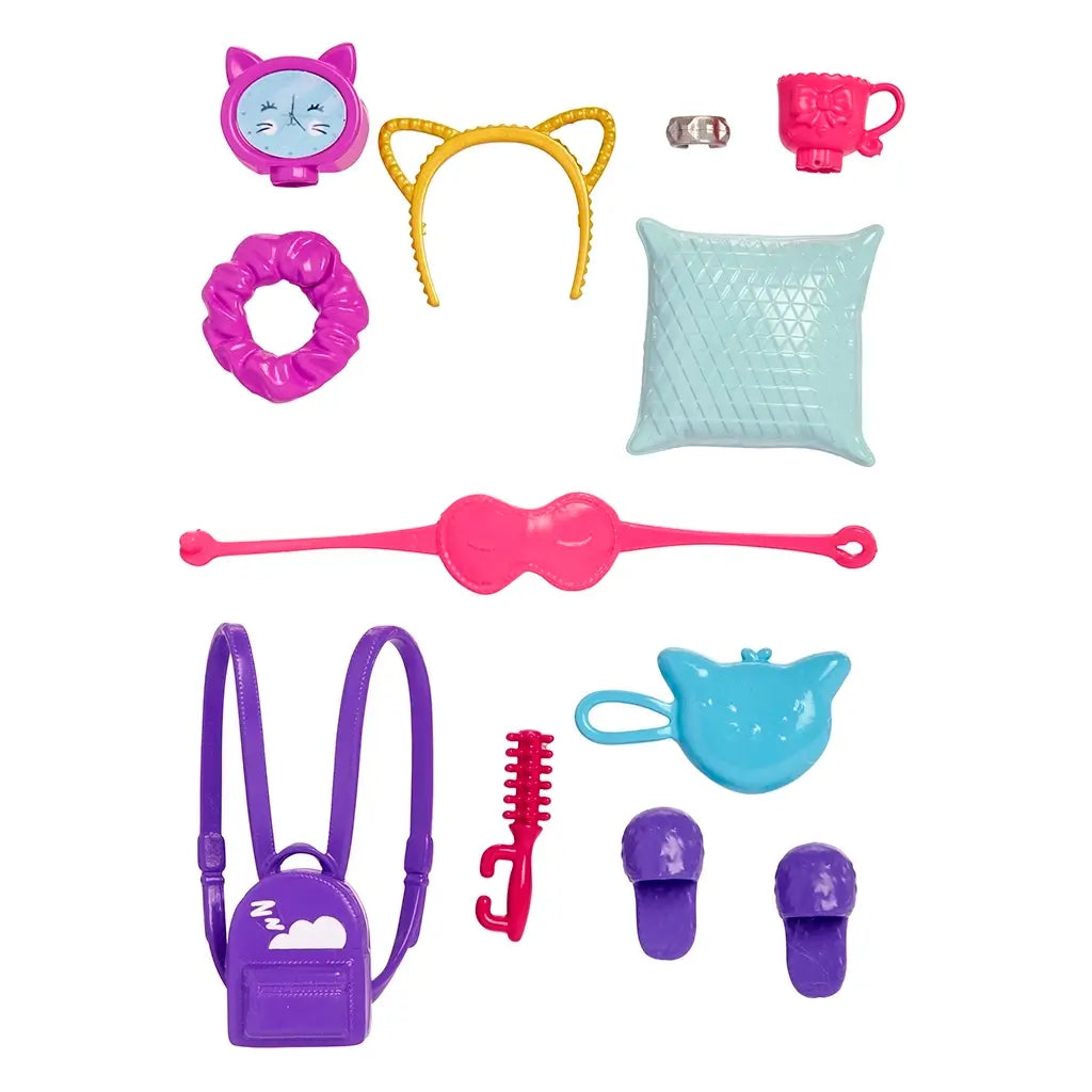Barbie accessory collection with purple backpack, slippers, blue pillow, pink sleep mask, yellow cat-ear headband, and matching travel cup for doll styling.
